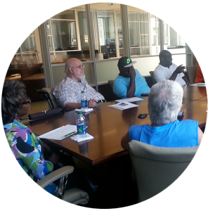 photo of customers talking around CAT board table