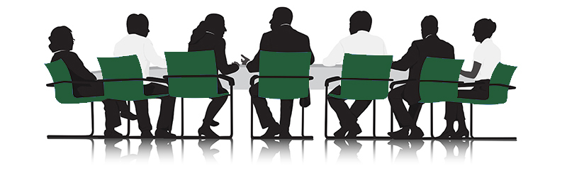 Seven people sitting at a desk